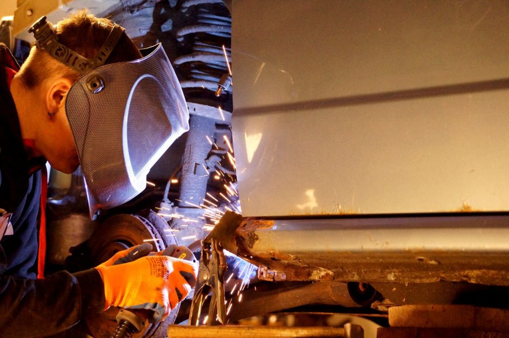 pexels photo 21071574 21071574 A skilled welder wearing protective gear working on metal with sparks flying in an industrial setting.